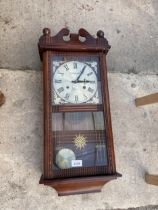 A WOODEN CASED 31 DAY CHIMING WALL CLOCK