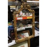 A VINTAGE STYLE GILT FRAMED MIRROR WITH CHERUB DETAIL ON THE FRAME, 34CM X 55CM