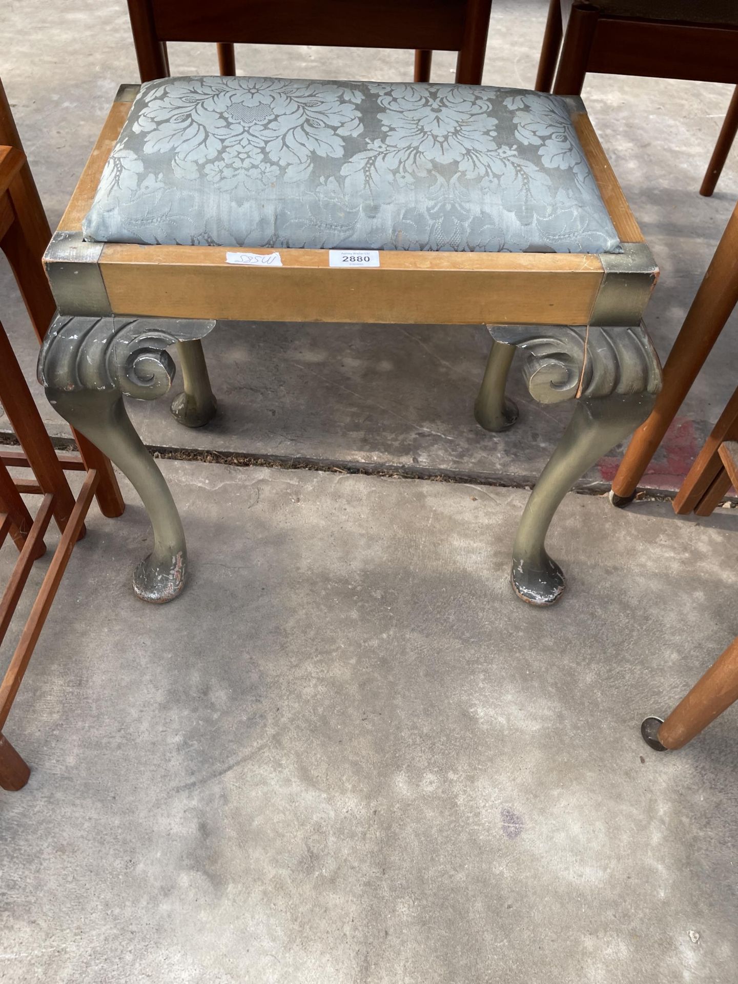 A GREEN PAINTED DRESSING STOOL ON CABRIOLE LEGS WITH BALL AND CLAW FEET