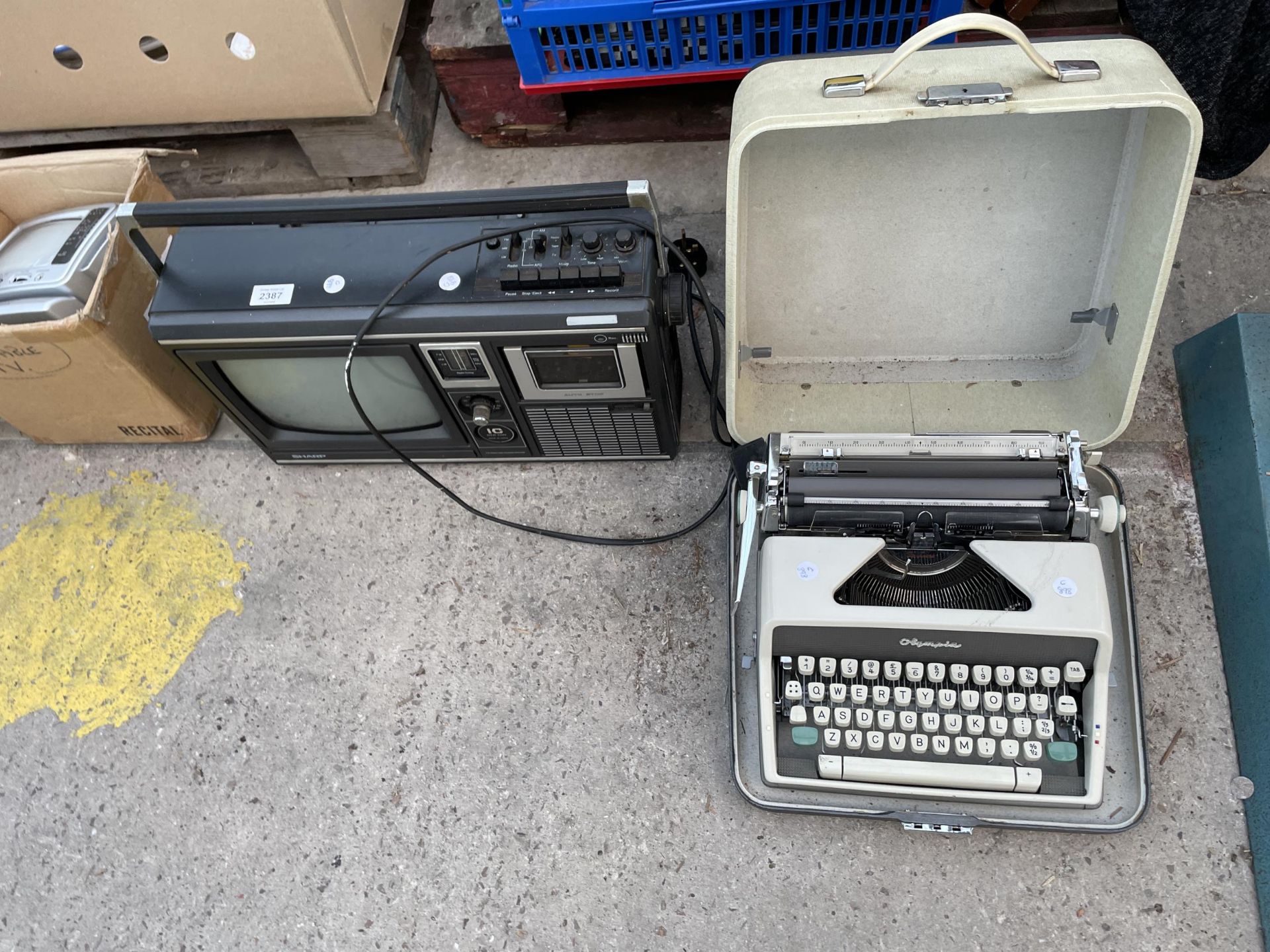 A RETRO SHARP RADIO AND A PORTABLE OLYMPIA TYPEWRITER