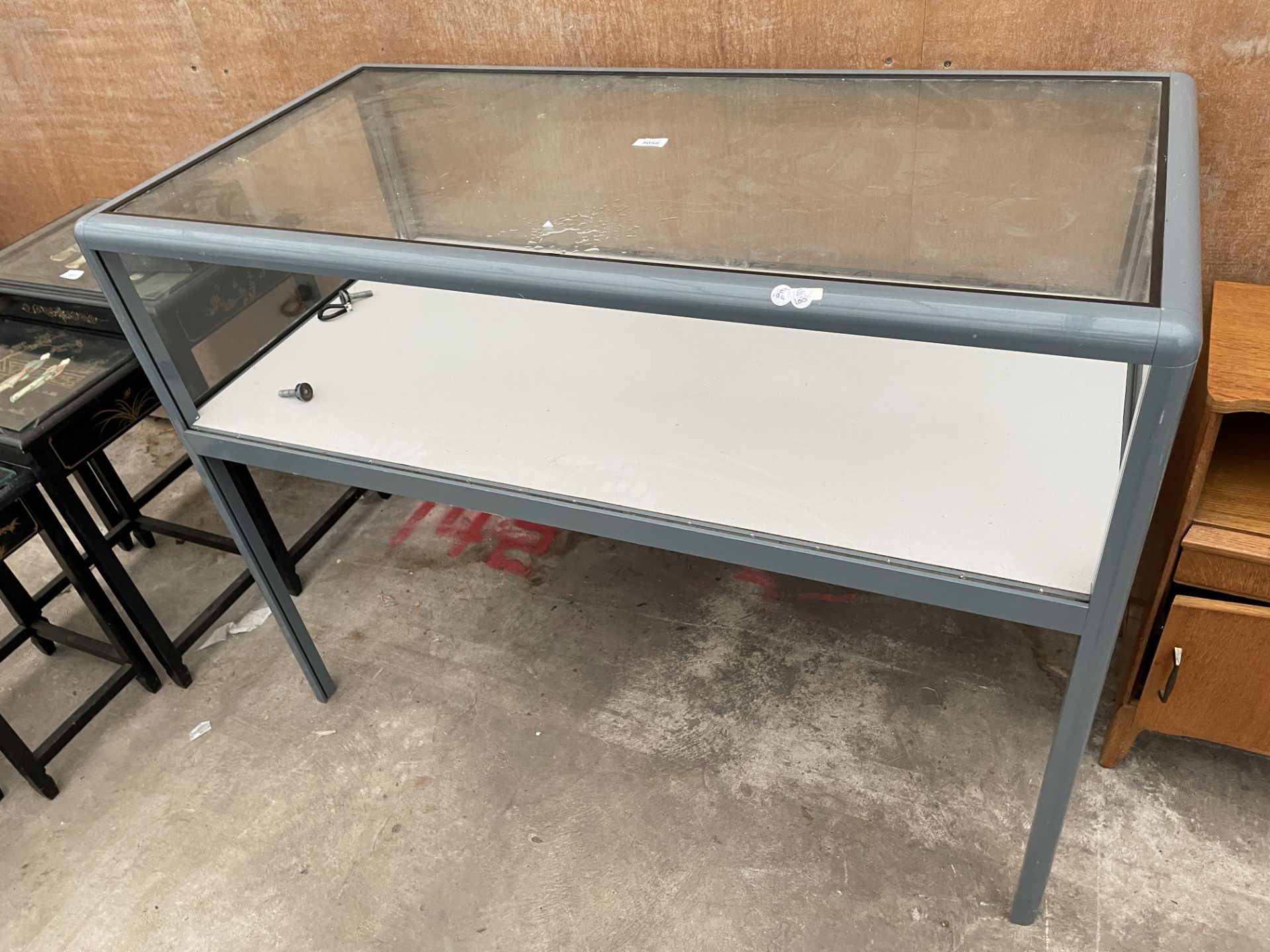 A MODERN METALWARE FRAMED GLASS DISPLAY COUNTER, 47 X 24"