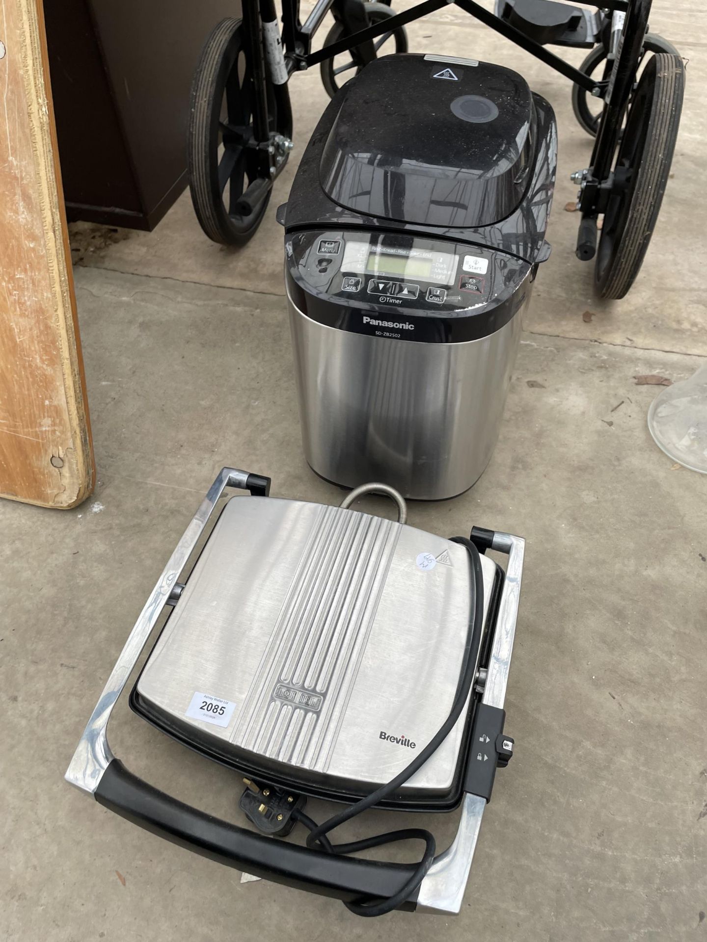 A BREVILLE PANINI MACHINE AND A PANASONIC BREAD MAKER