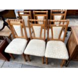 A SET OF FOUR MODERN PINE DINING CHAIRS WITH UPHOLSTERED SEATS AND BACKS