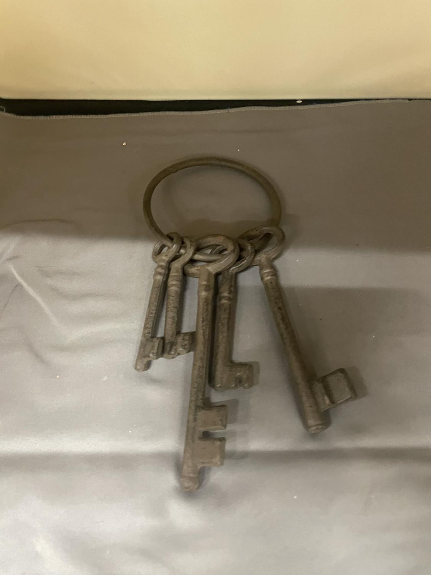 A SET OF FIVE LARGE CAST KEYS ON A LARGE RING