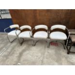 A SET OF FOUR TUBULAR CHROME ELBOW CHAIRS WITH WHITE LEATHER SEATS AND BACKS