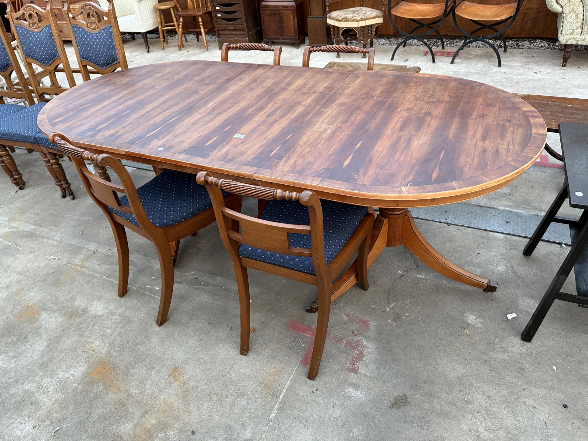 A REGENCY STYLE YEW WOOD CROSSBANDED TWIN PEDESTAL EXTENDING DINING TABLE 64" X 39.5" (LEAF 21.5")
