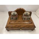 A DESK SET WITH LOWER DRAWER AND TWO ORIGINAL GLASS BOTTLES