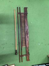 A VINTAGE WOODEN WEAVING IMPLEMENT PLUS A WALKING STICK WITH A WEIGHTED TOP
