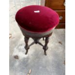 A LATE VICTORIAN REVOLVING PIANO STOOL WITH TURNED LEGS AND STRETCHERS