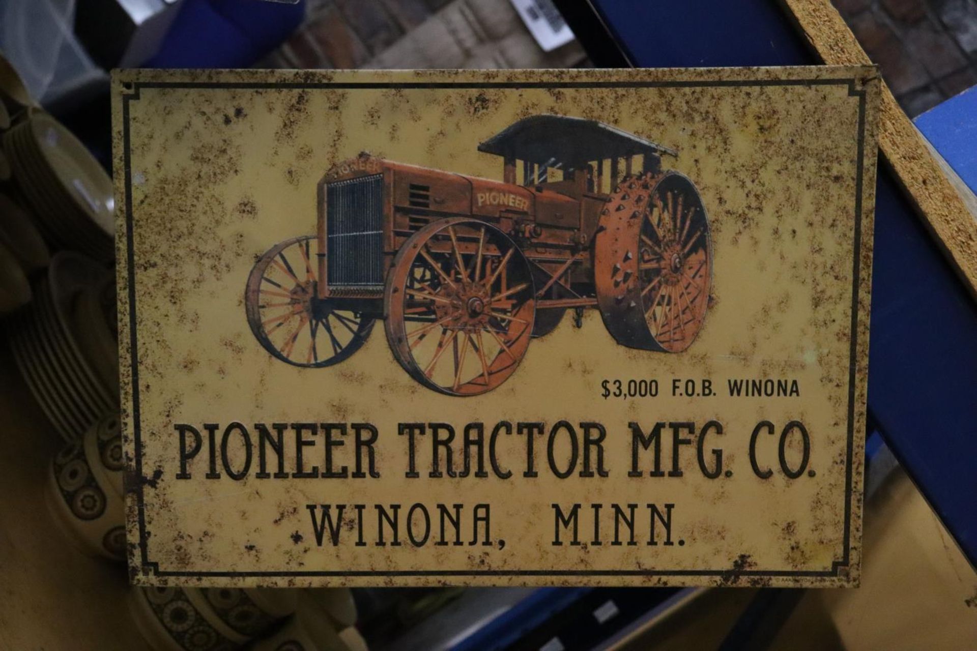 A METAL PIONEER TRACTOR SIGN