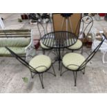 A DECORATIVE METAL PATIO BISTRO SET COMPRISING OF A ROUND TABLE AND FOUR CHAIRS WITH CUSHION SEATS