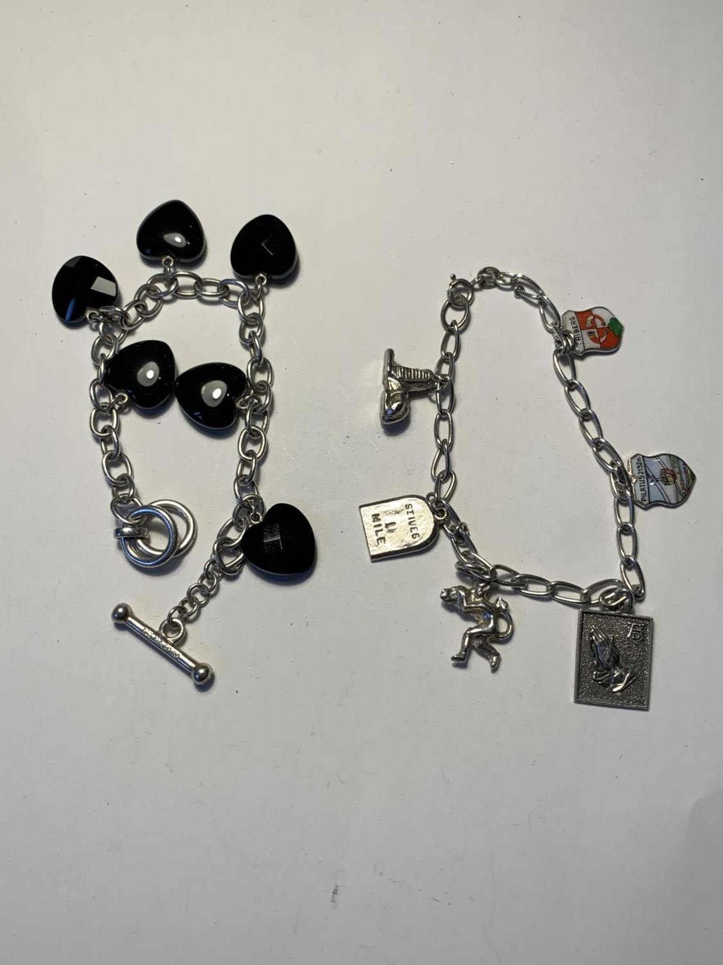 TWO SILVER BRACELETS WITH CHARMS