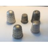 FIVE THIMBLES TO INCLUDE A HALLMARKED BIRMINGHAM, CHESTER, STERLING, INDISTINCT AND A FURTHER