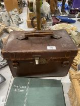 FOUR IDENTICAL BOWLING BOWLS, NUMBERED 1, 2, 3 AND 4 IN A VINTAGE LEATHER CASE