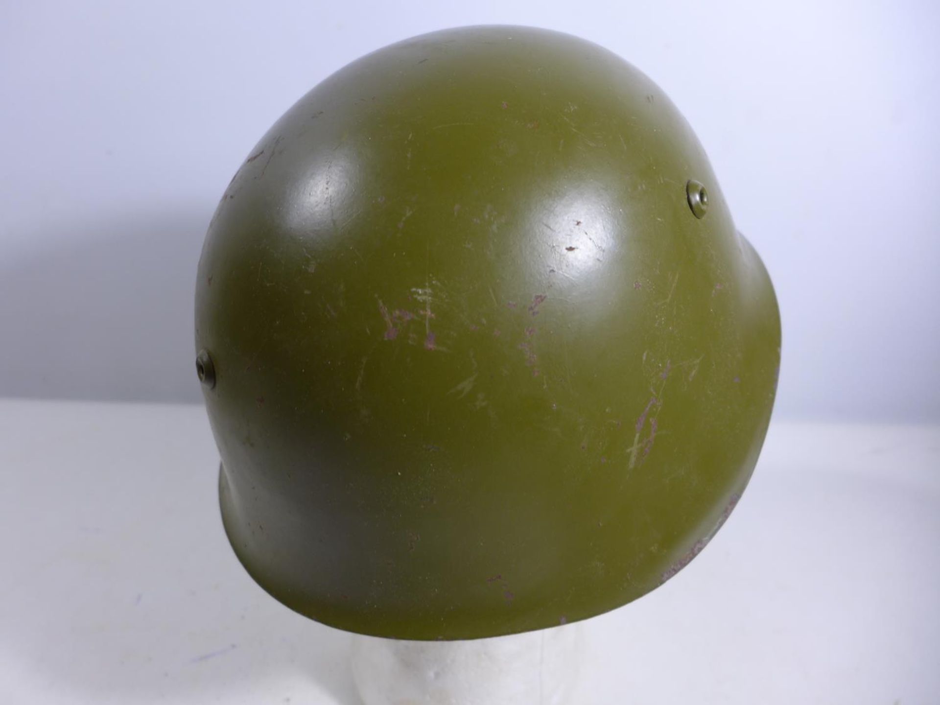 A GREEN PAINTED METAL MILITARY HELMET AND LINING - Image 2 of 4