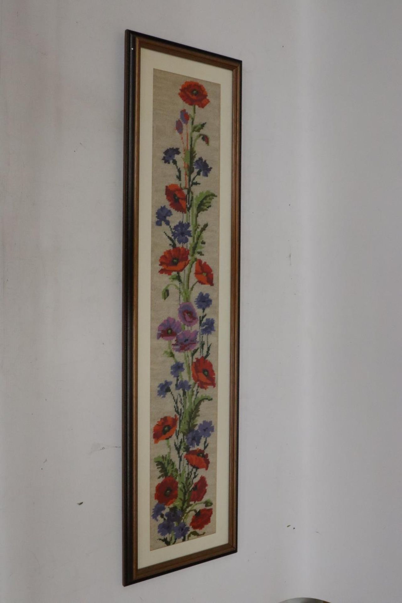 AN OIL ON BOARD OF FLOWERS, 41CM X 88CM AND A TAPESTRY OF FLOWERS, 26CM X 101CM
