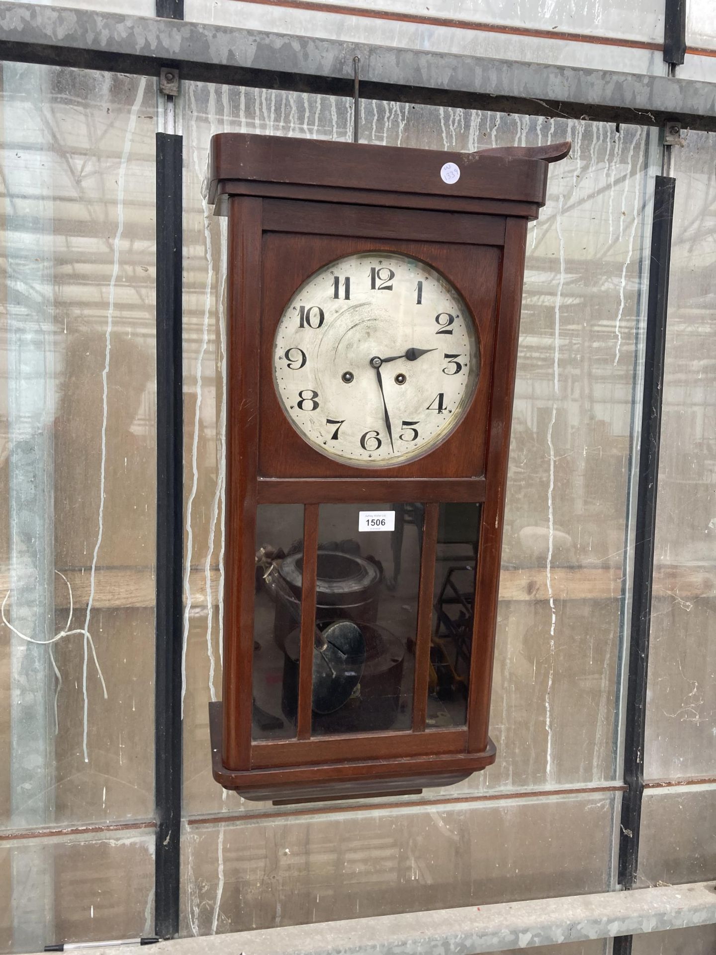 A VINTAGE MAHOGANY CASED CHIMING WALL CLOCK