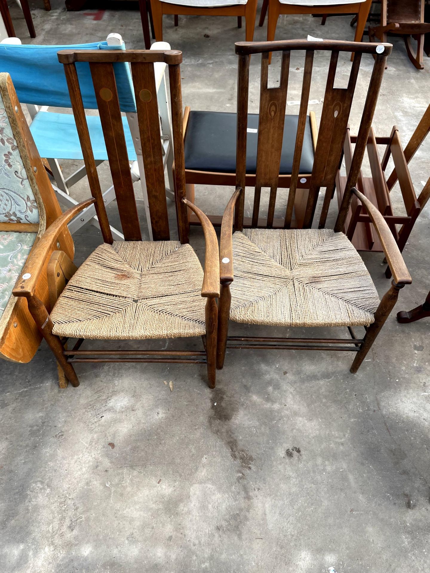 TWO ART NOUVEAU LIBERTY STYLE LOW ARMCHAIRS WITH INLAID WITH BACK PANELS AND RUSH SEATS