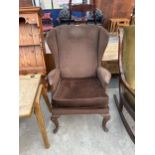 A PARKER KNOLL WINGED FIRESIDE CHAIR ON CABRIOLE FRONT LEGS MODEL NO. PK.918-19