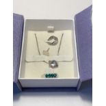 A SILVER NECKLACE, EARRING, AND RING SET IN A PRESENTATION BOX