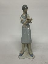 A LLADRO STYLE LADY FIGURE HOLDING A LAMB