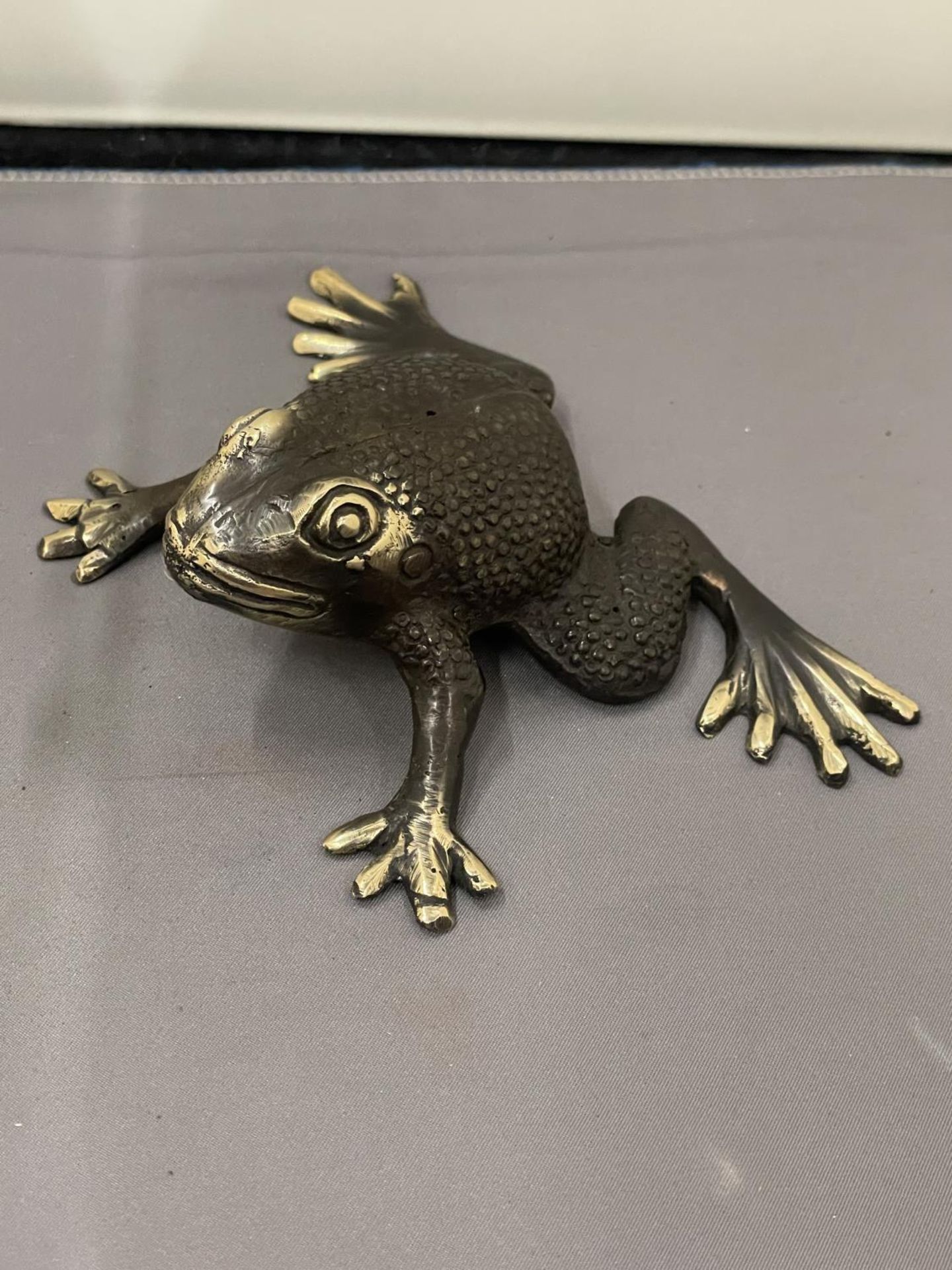 A BRONZE FIGURE OF A FROG