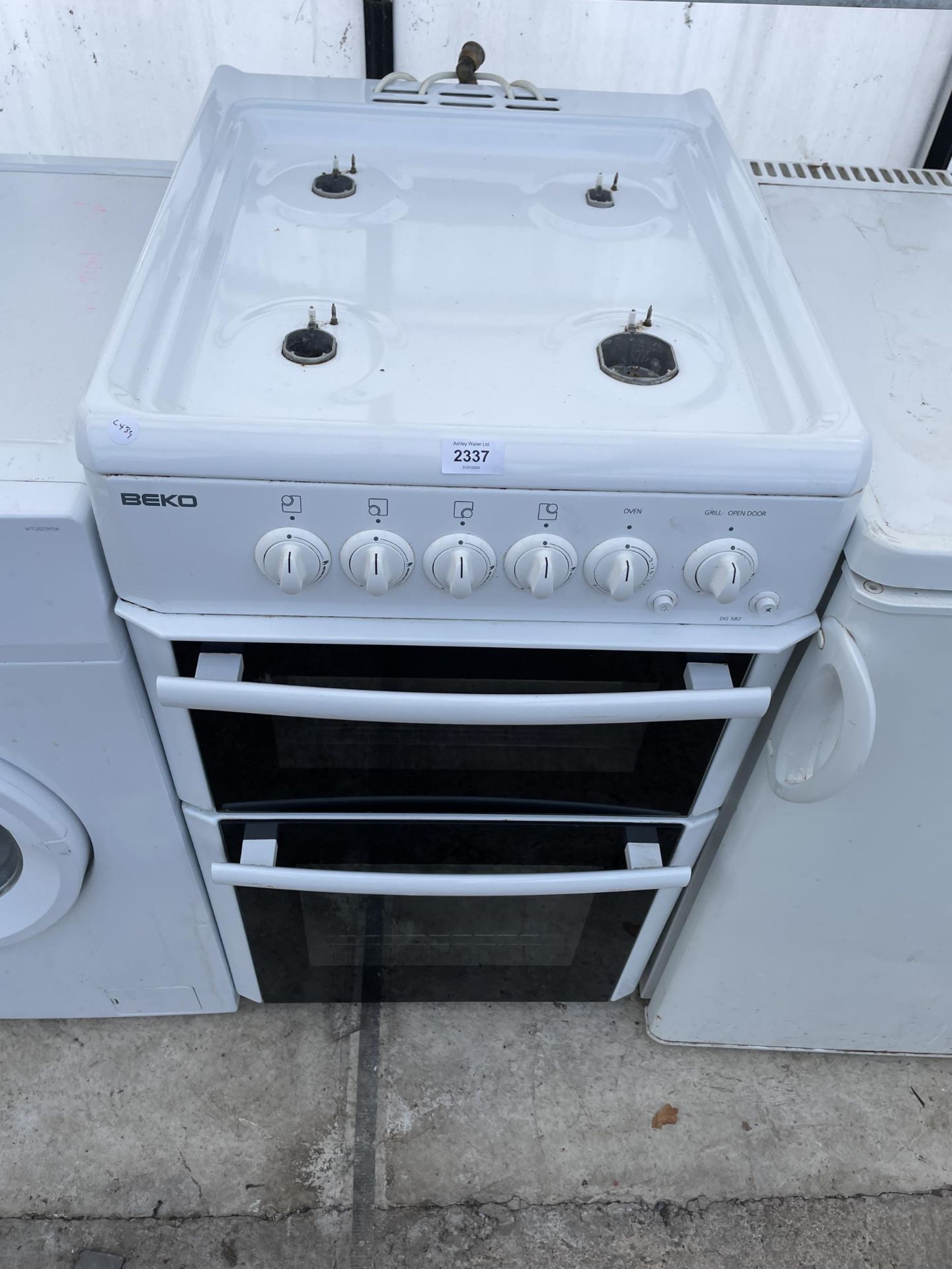 A WHITE AND BLACK FREESTANDING GAS OVEN AND HOB
