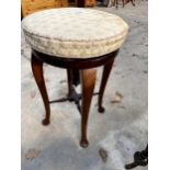 AN EARLY 20TH CENTURY MAHOGANY PIANO STOOL ON CABRIOLE LEGS AND TURNED STRETCHERS