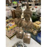 A PAIR OF STONE BUDDAH HEADS ON PLINTHS