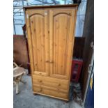 A PINE WARDROBE WITH TWO DOORS AND TWO DRAWERS - 32" WIDE