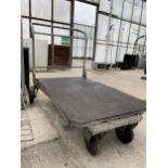 A METAL FOUR WHEELED MARKET GARDENERS TROLLEY IN WORKING ORDER BUT NO WARRANTY