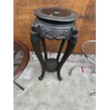 A VICTORIAN EBONISED TWO TIER JARDINIERE STAND WITH CARVED DECORATION AND CABRIOLE SUPPORTS - 35"