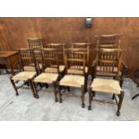 A SET OF EIGHT ELM AND BEECH LANCASHIRE SPINDLE BACK DINING CHAIRS, TWO BEING CARVERS, WITH RUSH