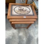 A STAMPED 'MADE IN DENMARK' RETRO TEAK NEST OF THREE TABLES WITH TILED TOPS