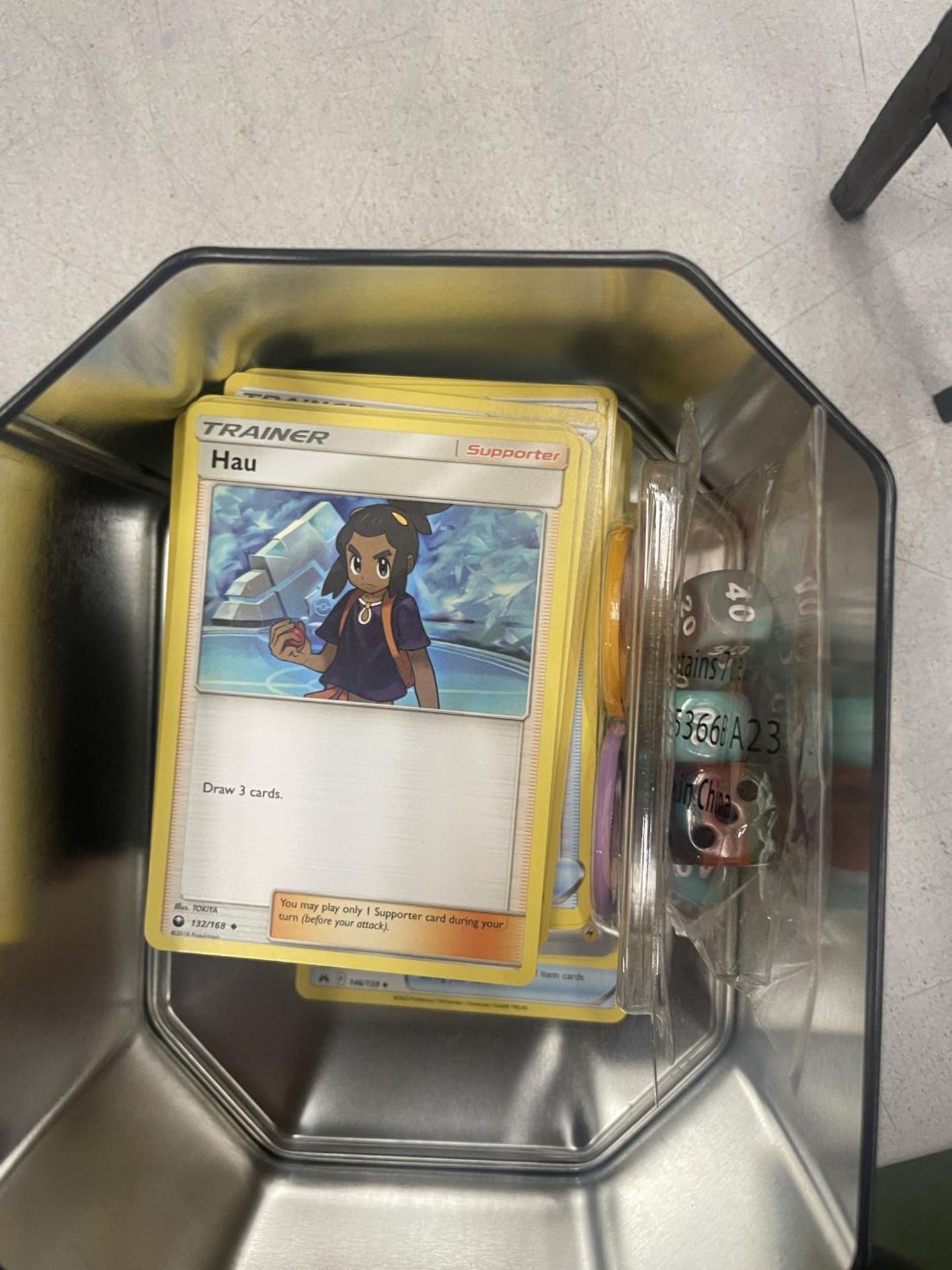 A POKEMON COLLECTOR'S TIN FULL OF CARDS, DICE, COINS AND SHINIES - Image 2 of 2