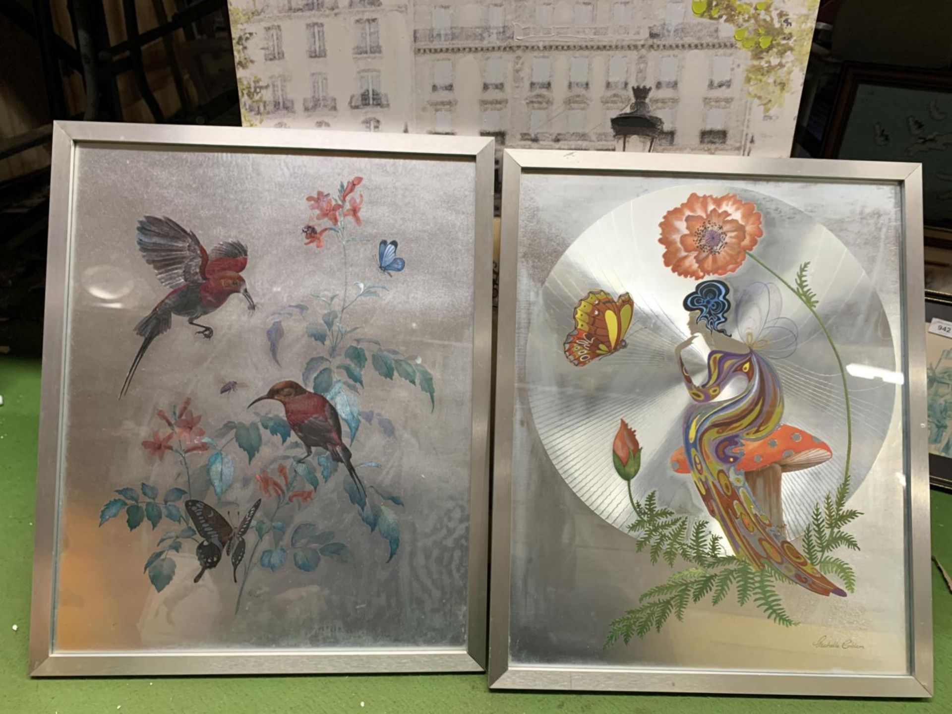 TWO FRAMED PRINTS WITH A SILVERED BACKGROUND, ONE OF BIRDS, THE OTHER A FAIRY SITTING ON A TOADSTOOL