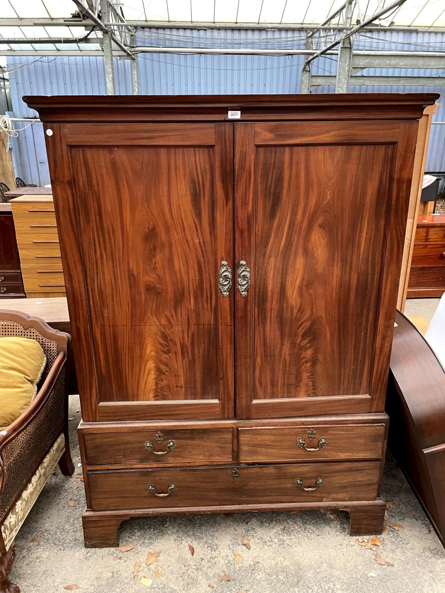 A GEORGIAN MAHOGANY PRESS WITH THREE SLIDES, ONE DRAWER TO THE UPPER PORTION, AND TWO SHORT, ONE