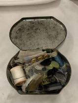 A VINTAGE TIN CONTAINING SEWING ITEMS