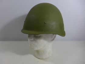 A GREEN PAINTED METAL MILITARY HELMET AND LINING