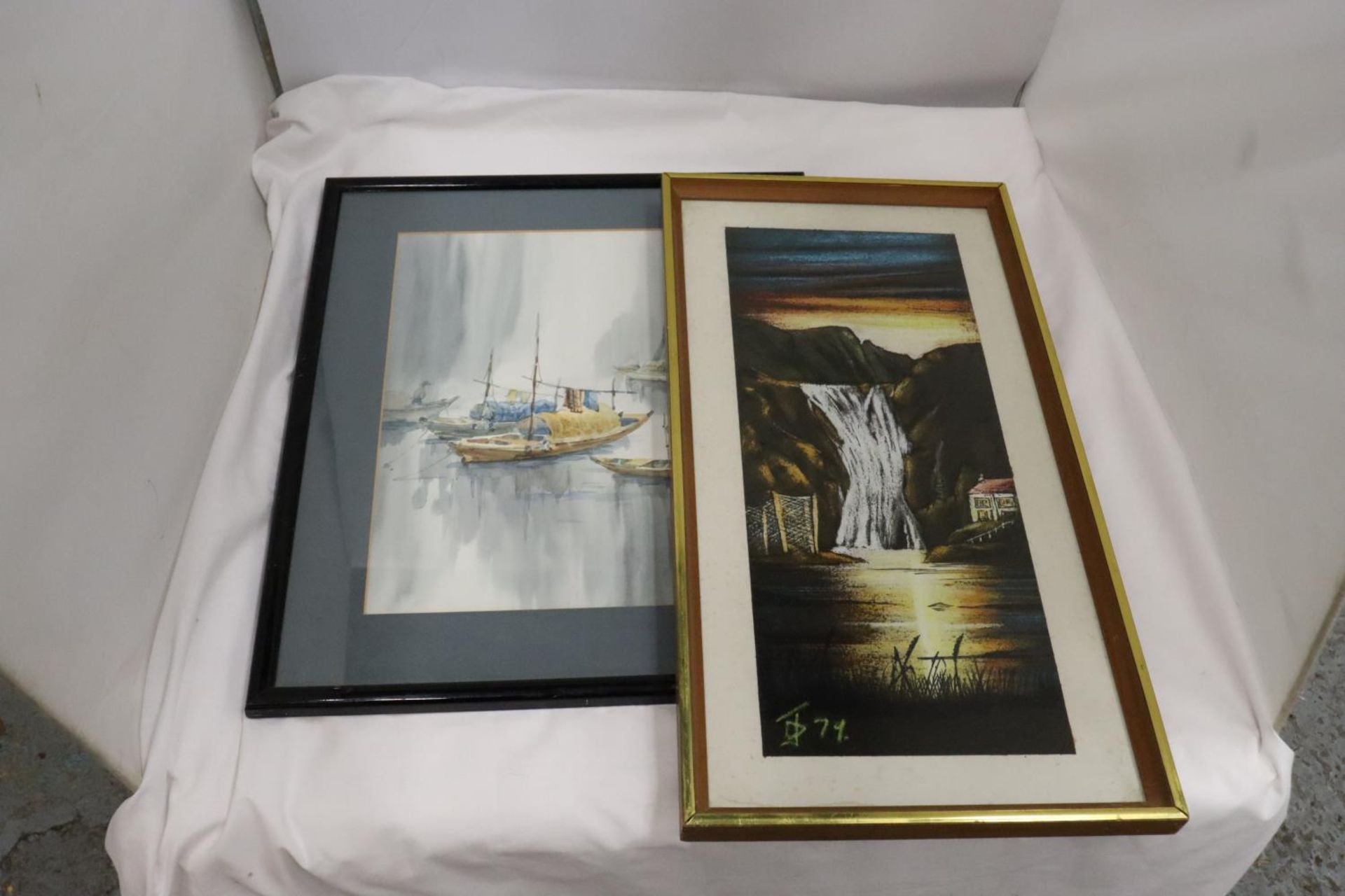 TWO FRAMED PRINTS ONE OF A WATERFALL AND AN ORIENTAL OF BOATS