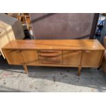 A RETRO TEAK YOUNGER SIDEBOARD ENCLOSING FOUR DRAWERS AND FOUR CUPBOARDS, 84" WIDE