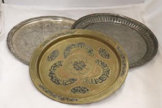 A SILVER PLATE ON COPPER TRAY TOGETHER WITH TWO EASTERN STYLE TRAYS