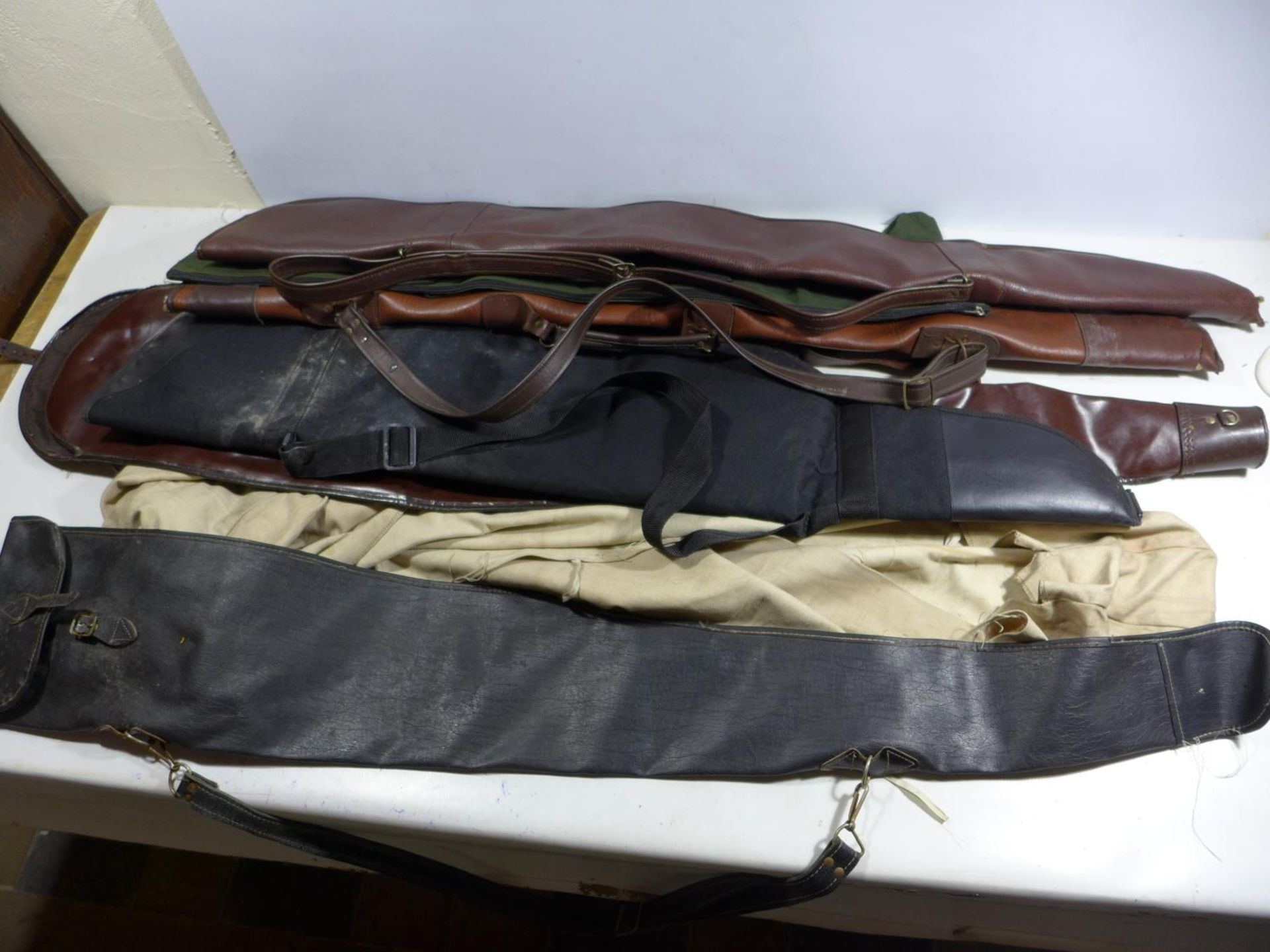 SEVEN ASSORTED GUN SLIP CASES