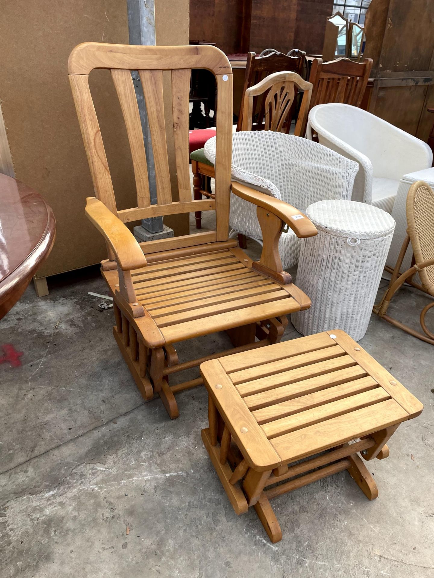A MODERN FORWARD SLIDE SLATTED ROCKING CHAIR AND MATCHING STOOL