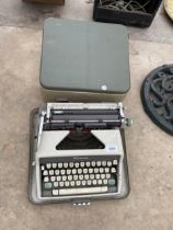 A RETRO OLYMPIA TYPEWRITER WITH CARRY CASE