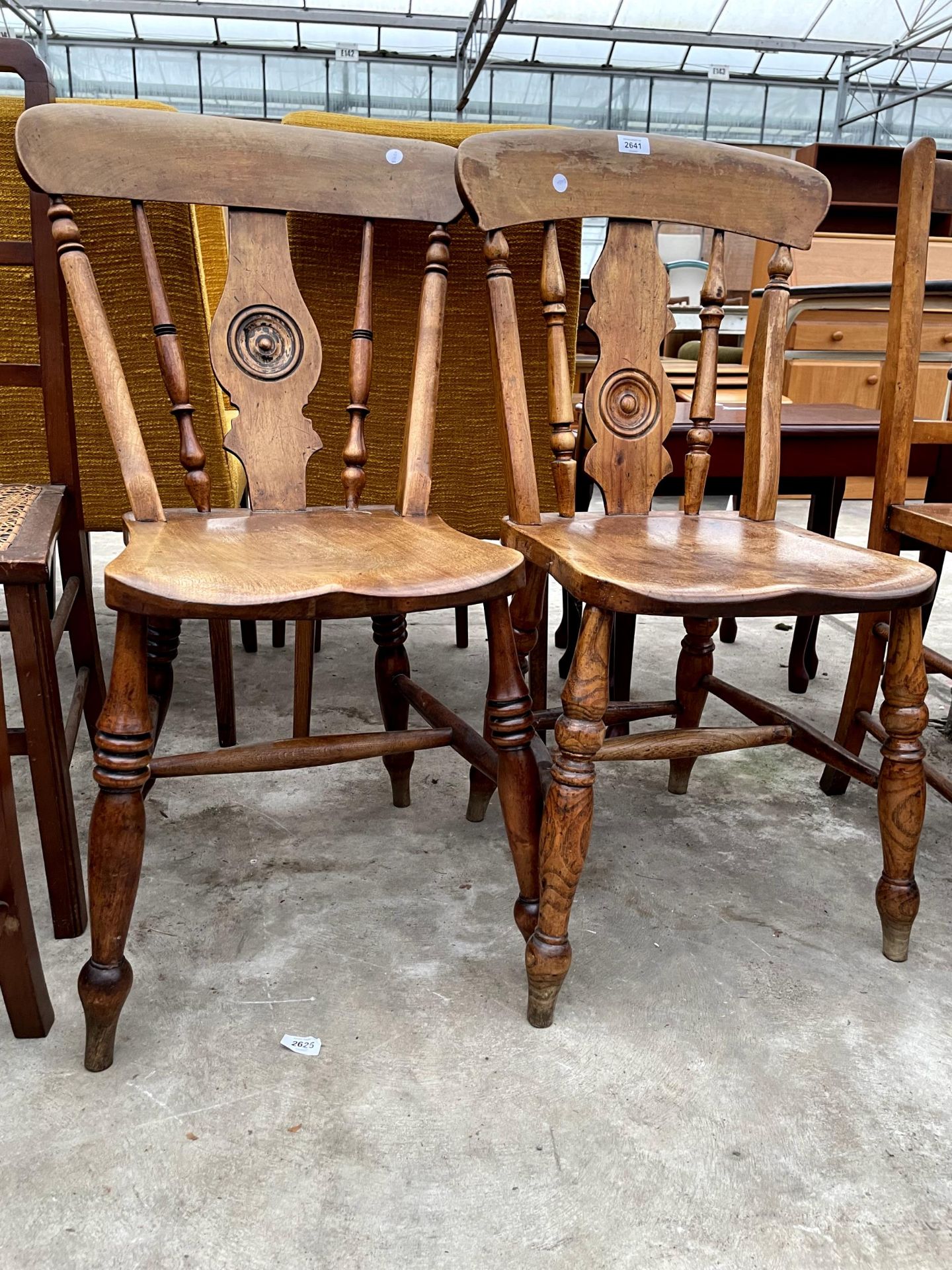 A PAIR OF VICTORIAN ELM AND BEECH KITCHEN CHAIRS WITH BULLSEYE BACKS - Image 2 of 2