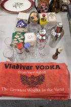 A COLLECTION OF ITEMS TO INCLUDE A STAINLESS STEEL AND GLASS COCKTAIL SHAKERS, BAR TOWELS, BRANDED
