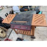 A BONDI GAS BBQ WITH WOODEN TABLE TROLLEY