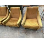 A PAIR OF RETRO DANISH EASY CHAIRS WITH SWEPT ARMS ON TAPERING LEGS WITH BUTTON BACK