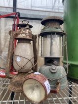 TWO VINTAGE PARAFIN LAMPS AND A VINTAGE MOTOR VEHICLE HEAD LAMP